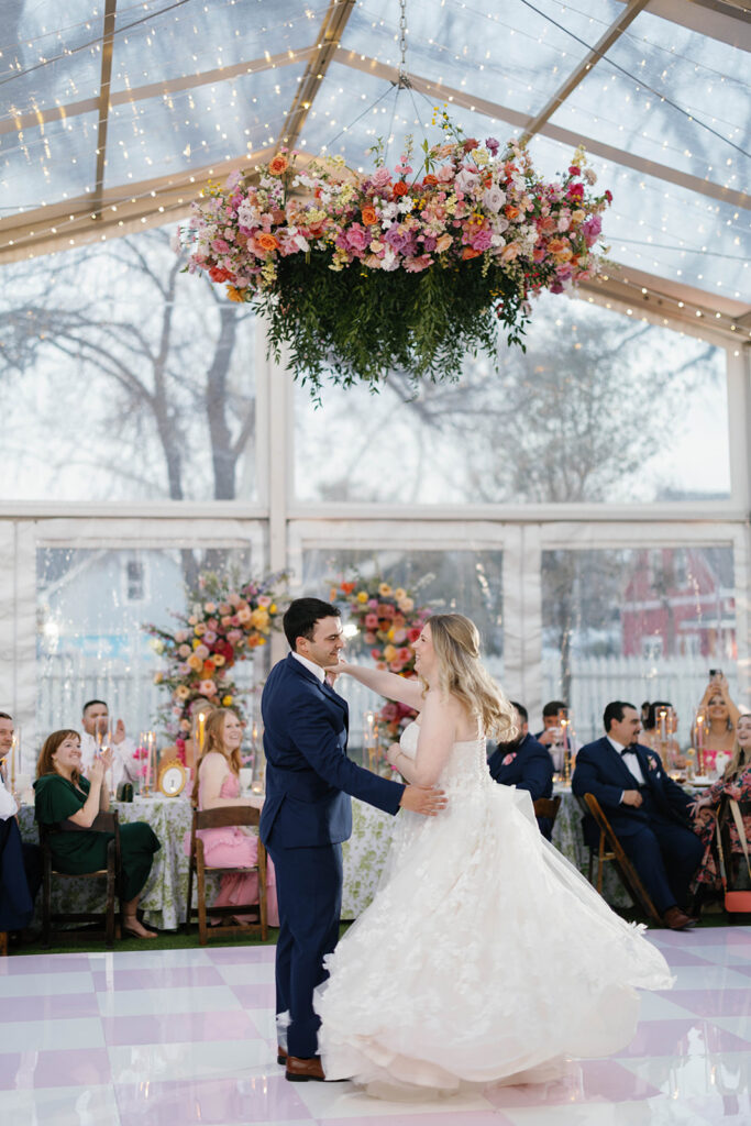 Whimsical reception tablescape with garden roses and candlelight at Woodbine Mansion