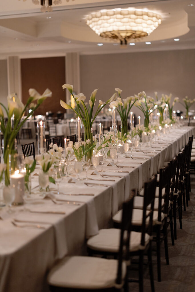 Wedding reception inside the Four Seasons Austin ballroom with soaring ceilings and elegant decor