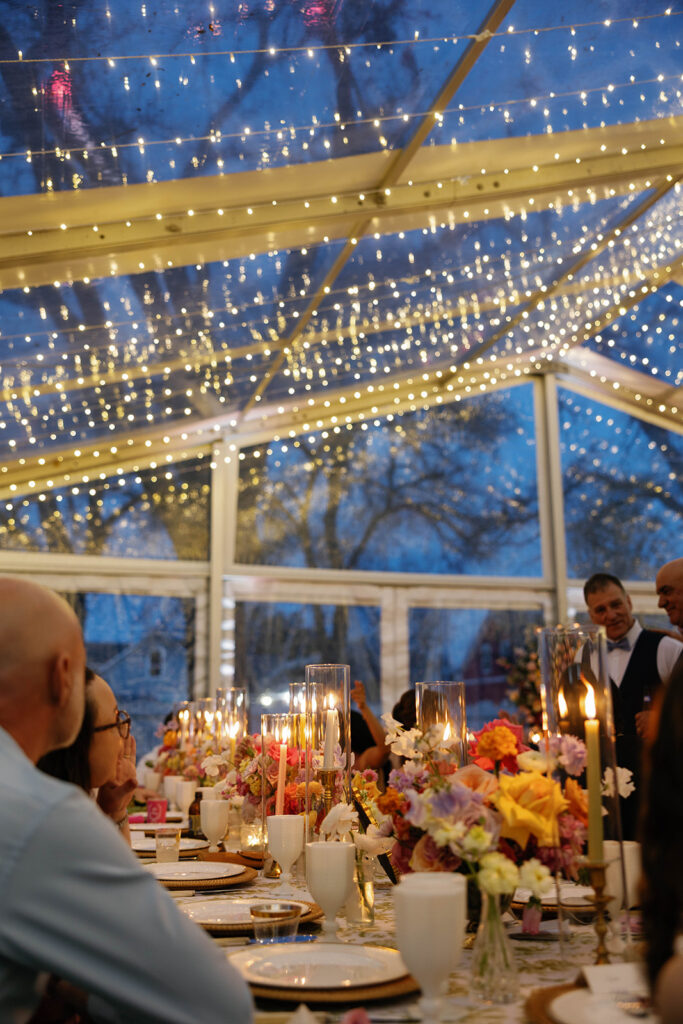 Whimsical reception tablescape with garden roses and candlelight at Woodbine Mansion