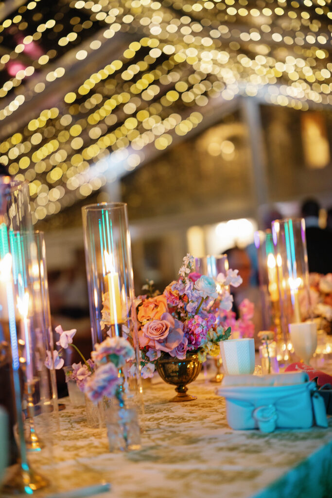 Whimsical reception tablescape with garden roses and candlelight at Woodbine Mansion