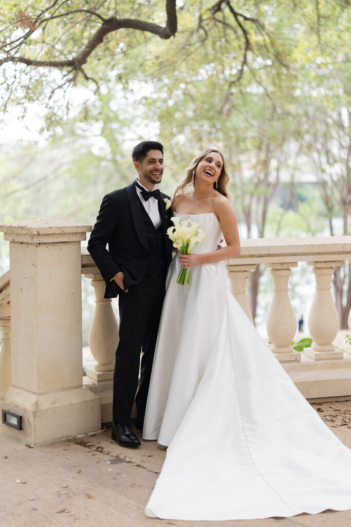 Outdoor wedding ceremony on the back lawn at Four Seasons Austin with Lady Bird Lake in the background