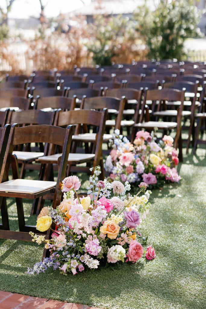 Outdoor wedding ceremony under oak trees at Woodbine Mansion in Round Rock Texas