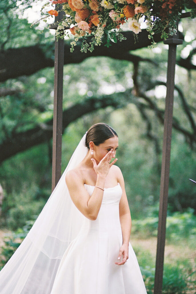 Bride and groom exchanging vows beneath the Sacred Oaks at Camp Lucy, Austin wedding photographer