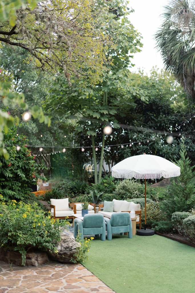 String lights and garden greenery at Hummingbird House, a secret garden wedding venue near Austin