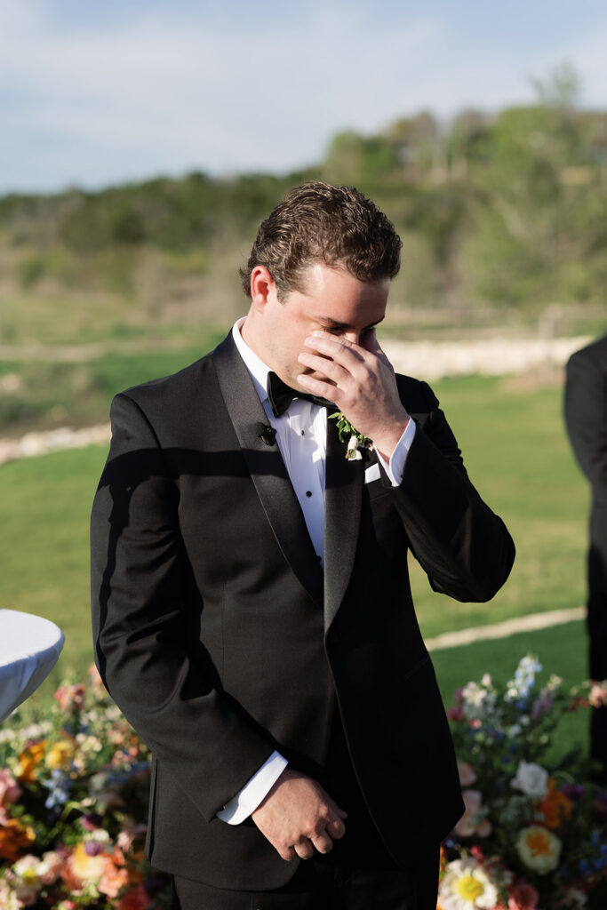 Groom wiping away tears as bride walks down the aisle at La Cantera Resort & Spa