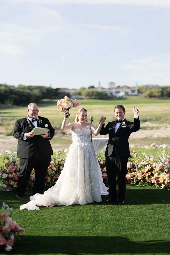 Bride and groom walking back down the aisle as newlyweds at La Cantera Resort & Spa