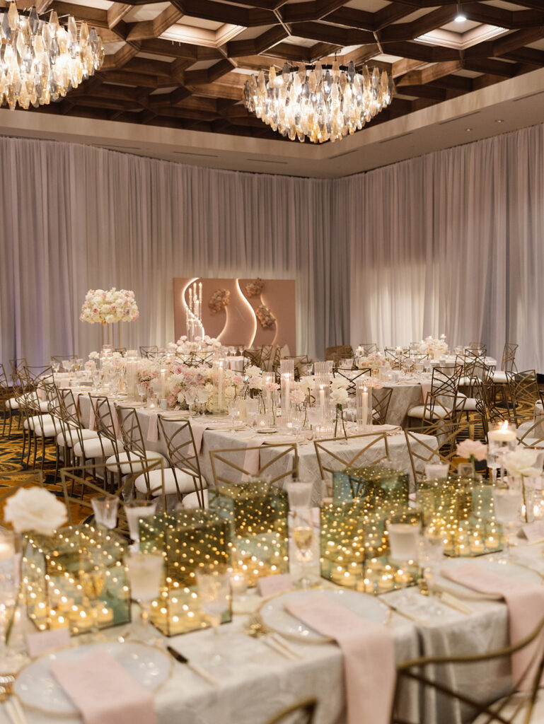 Cream and blush ballroom reception with candlelight at a Texas Hill Country wedding