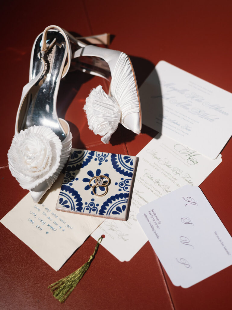 Wedding details and rings laid out before Southwest School of Art ceremony