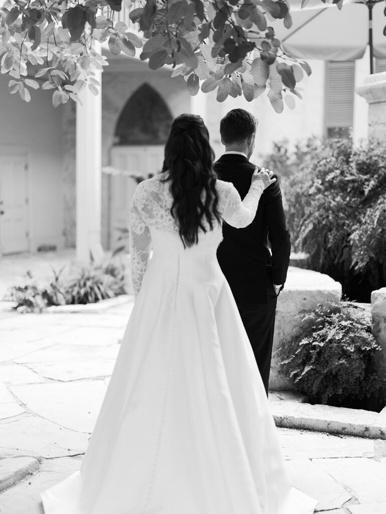 Bride tapping groom's shoulder during first look at Southwest School of Art