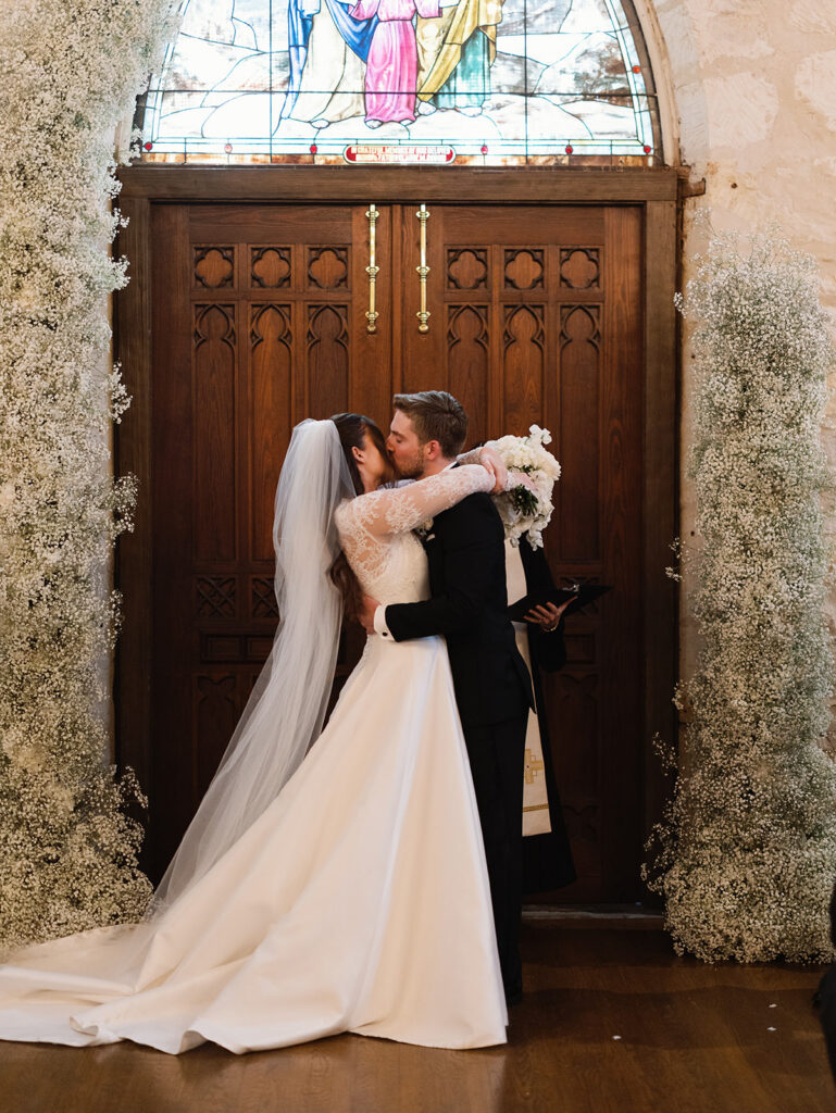 First kiss as newlyweds inside Coates Chapel at Southwest School of Art
