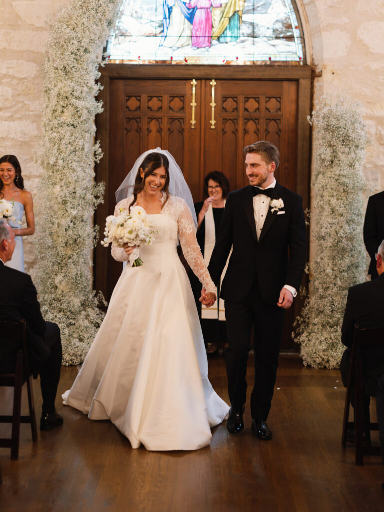 Bride and groom walking back down the aisle after Coates Chapel ceremony