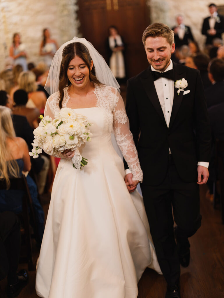 Bride and groom walking back down the aisle after Coates Chapel ceremony