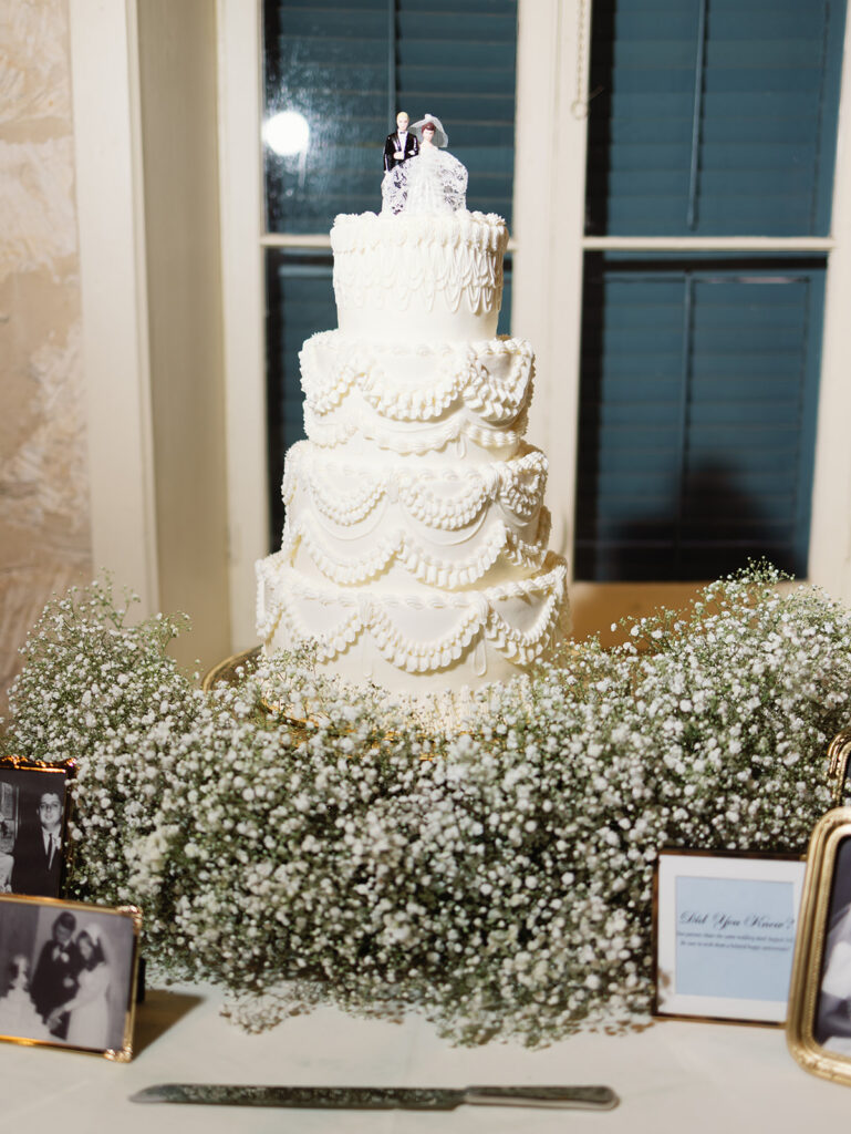 Wedding cake and florals at candlelit Southwest School of Art reception