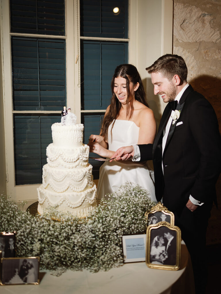 Wedding cake and florals at candlelit Southwest School of Art reception