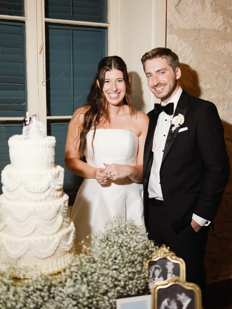 Wedding cake and florals at candlelit Southwest School of Art reception