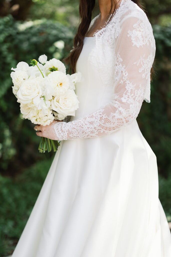 Bride's dress detail against Southwest School of Art stone walls